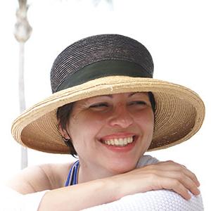 Grace Sikorski wearing a hat and smiling while looking over her shoulder