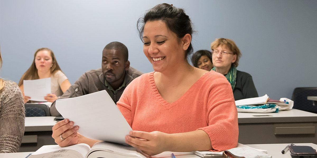 AACC student reviewing a handout in her classroom.